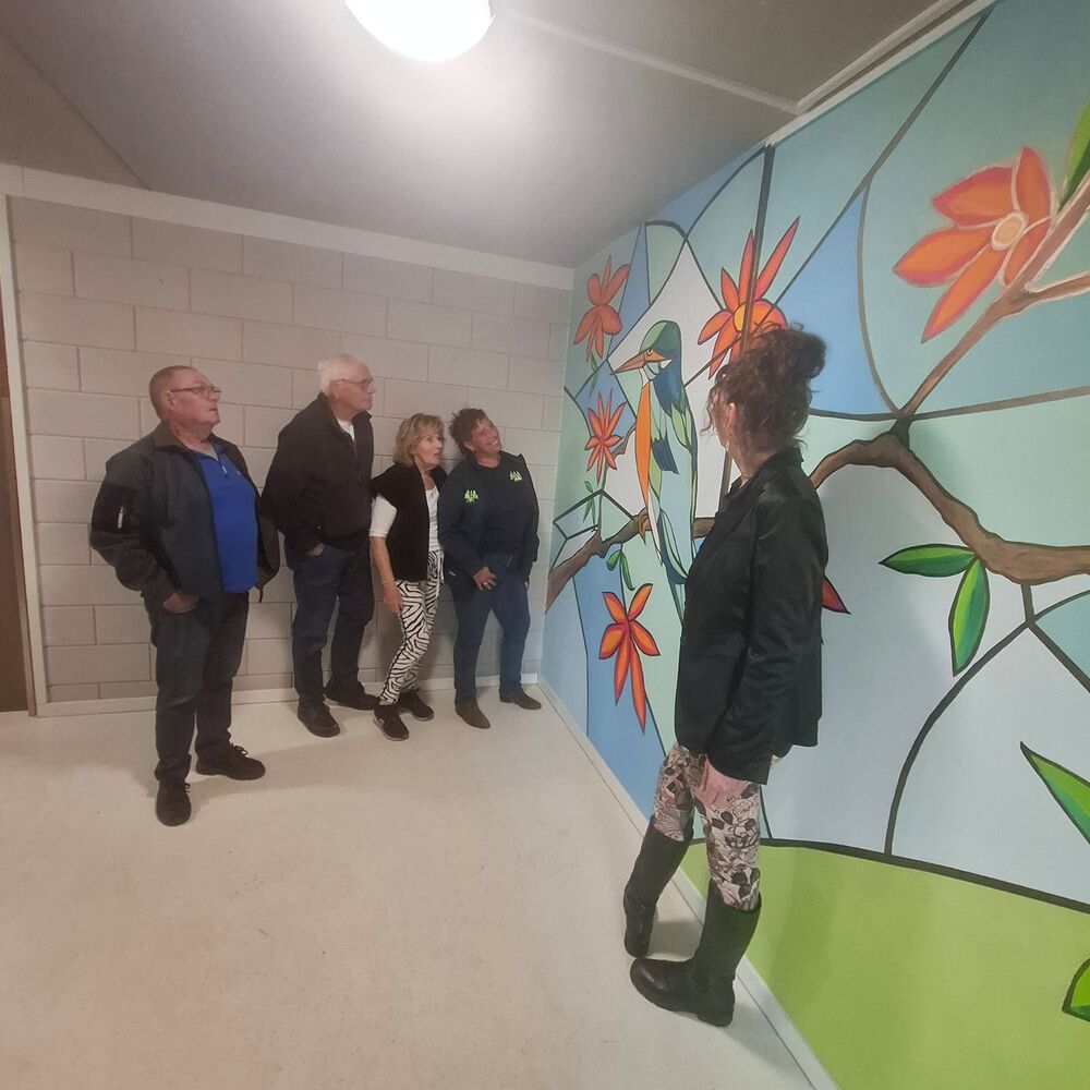 Huurders en kunstenares Julia Jiskoot voor wandschildering roodborstje